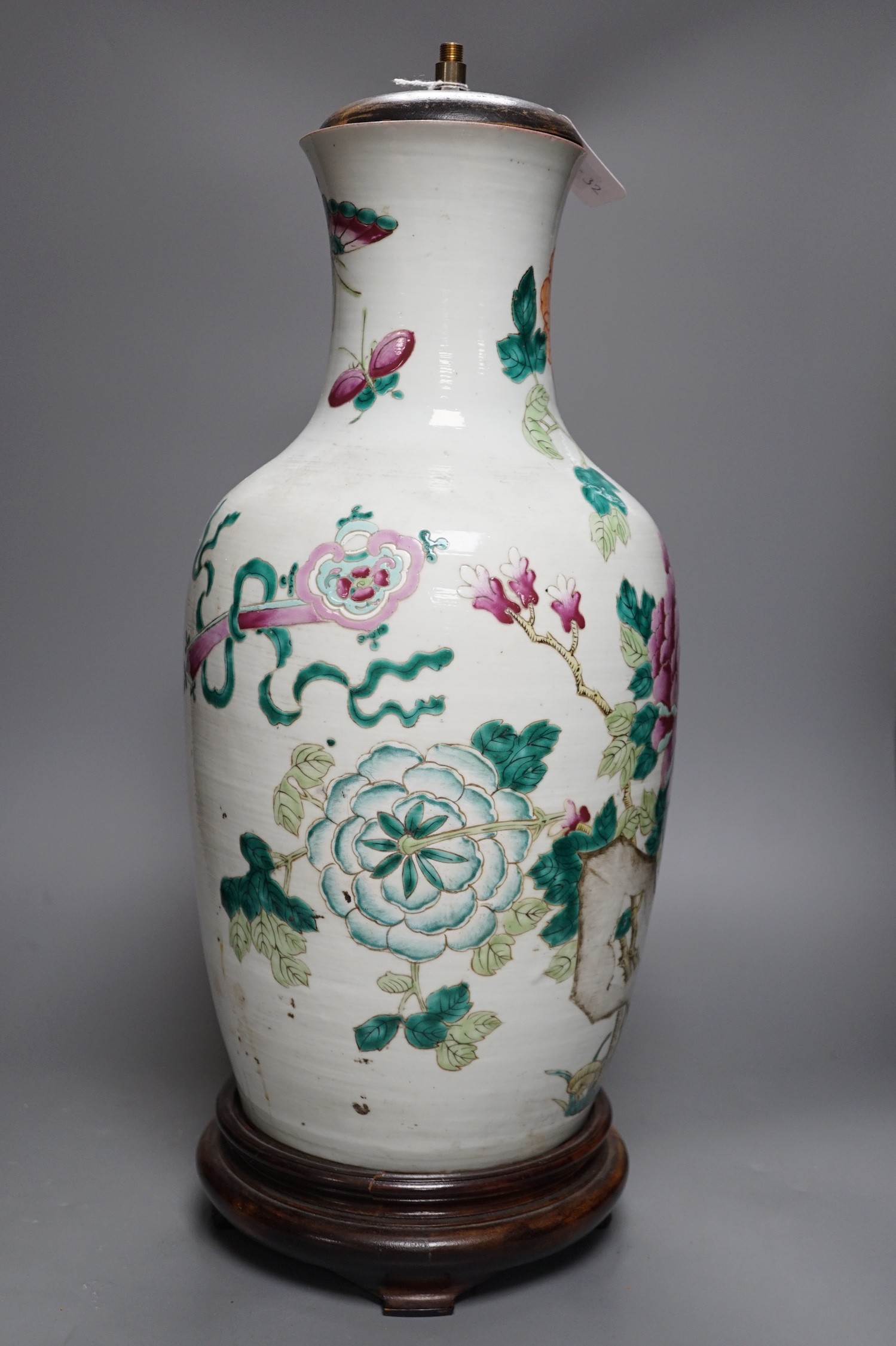 A large Chinese famille rose ‘peony and rockwork’ vase, converted into a lamp on wooden base, 53cm tall